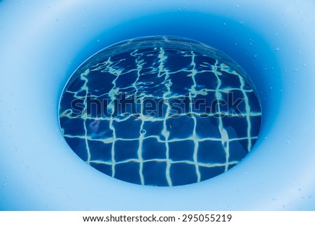 Blue swim ring in the pool.