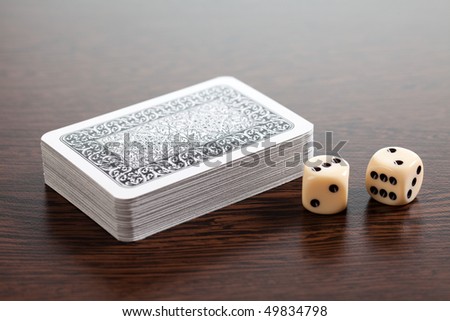 poker cards and dices on wooden table