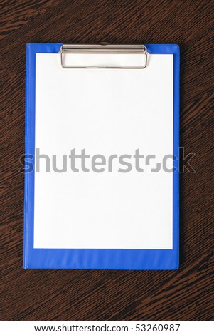 blank clipboard on wooden background