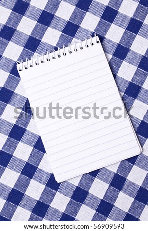 spiral notepad on picnic tablecloth