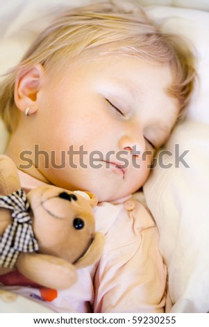 sleeping child with teddy bear