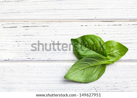 the basil leaves on kitchen table