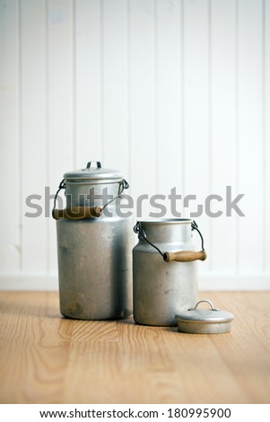 vintage milk cans on wooden floor