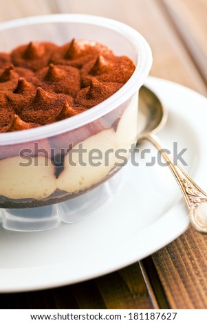 dessert tiramisu in cup on kitchen table