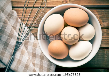 Similar – Image, Stock Photo Eggs in a bowl and baking ingredients on a kitchen table. Rustic.