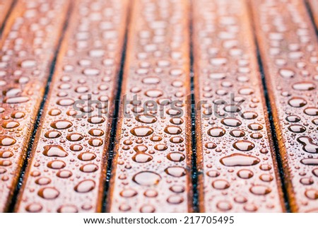 the water drops on wooden garden table
