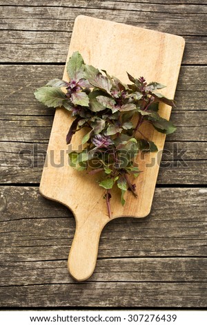 bunch of basil on old wooden table