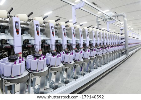 LUANNAN, CHINA - JAN 13: a functioning of spinning equipment is operating within the factory, ze the spinning mill on December 13, 2013, LUANNAN county, hebei province, China.