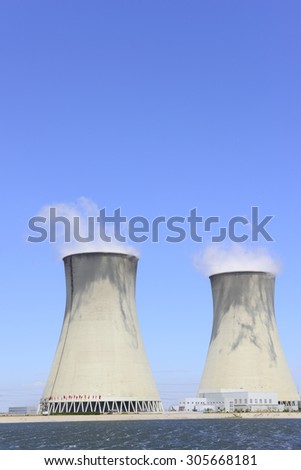 Power plant chimney under the blue sky, close-up