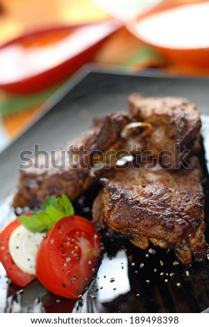 Grilled beef with tomatoes and mozzarella .Serving grilled poultry meat served on white ceramic plate