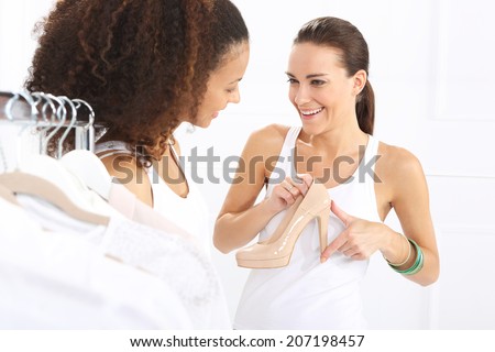 Sale, friend shopping .Two women shopping in boutique clothing, mulatto and Caucasian