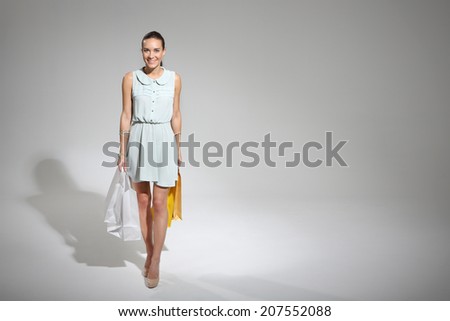Happy woman - a successful shopping ..  Young, attractive girl in a summer dress with a large bag purchasing