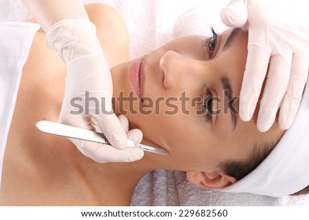 Scalpel, plastic surgery.Caucasian woman during surgery using a scalpel