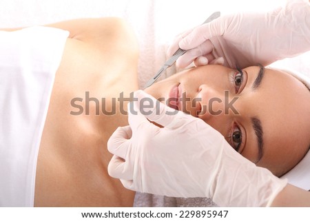 Plastic surgery wrinkle reduction.Caucasian woman during surgery using a scalpel