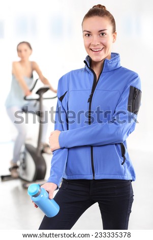 Gymnastic training on a bicycle. Slim figure of a woman dressed in a sports gym background