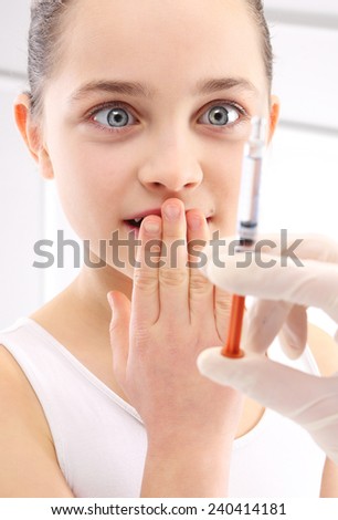 Fear of injections, the child with the nurse.The girl in the treatment room, the nurse does an injection in the arm