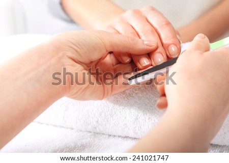 Beauty salon, manicure. Treatment hand and nail care, the woman to a beautician for a manicure.