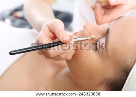 Make up artist, makeup professional in the beauty salon.Woman in a beauty salon, makeup artist applied primer for face