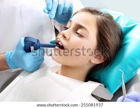 Tooth decay in children, oral hygiene. Child in the dental chair dental treatment during surgery.