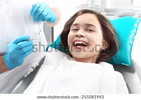 Dentistry, joyful child in the dental chair. Child in the dental chair dental treatment during surgery.