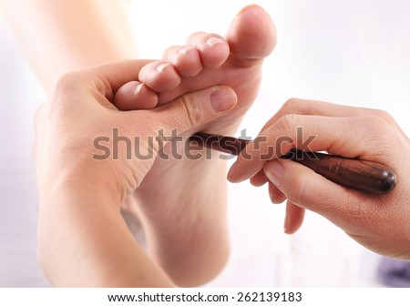 Foot massage, Foot reflexology.Natural medicine, reflexology, acupressure foot massage oppresses energy flow points