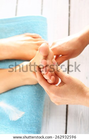 Prepare feet before the summer. Woman in a beauty salon for pedicure and foot massage.