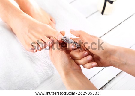 Nail clipping, cutting skins pedicure treatment.Foot care treatment and nail, the woman at the beautician for pedicure.
