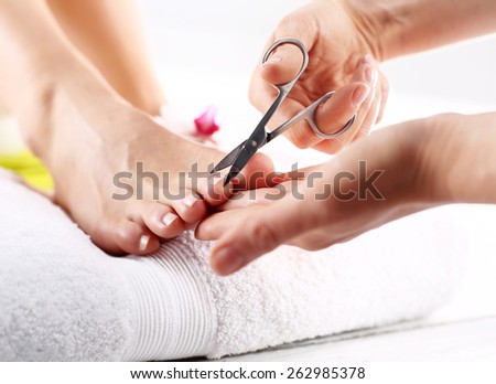 Nail clipping, cutting skins pedicure treatment. Foot care treatment and nail, the woman at the beautician for pedicure.