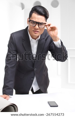 Interview, employee recruitment.Handsome man in business suit sitting at his desk in his office.