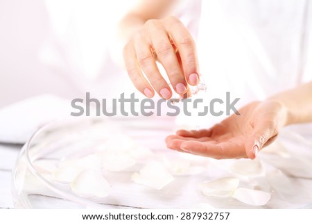 Skin cleansing.\
Hands of a woman holding cotton swabs to clean the skin