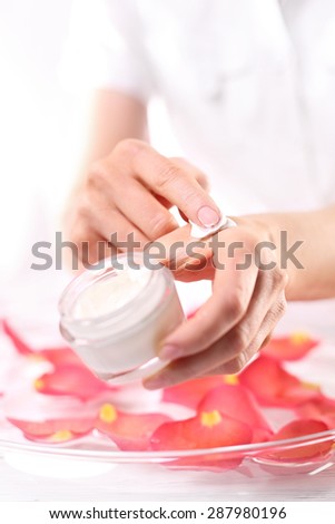 Creaming hands, velvety skin of hands.\
The woman imposes on hand care cream.