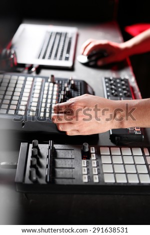 Mixing console, DJ job in the disco. Hands DJ mixing music at the club during the event