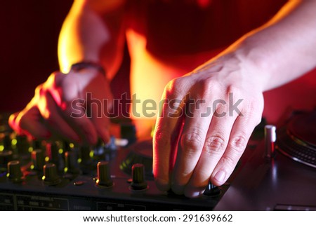 Club music. Hands DJ mixing music at the club during the event