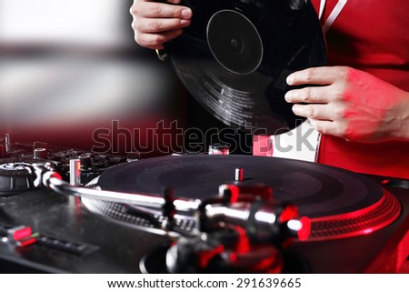Vinyl, music with soul. Hands DJ mixing music at the club during the event