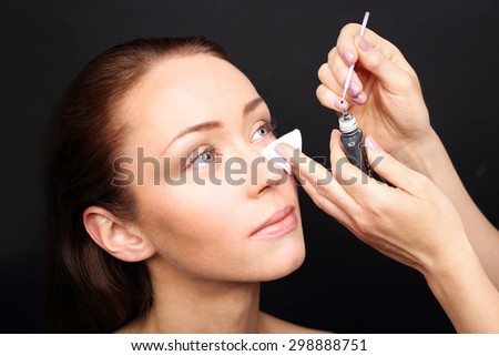 Eyelash extensions. Woman during surgery eyelash extensions and permanent makeup