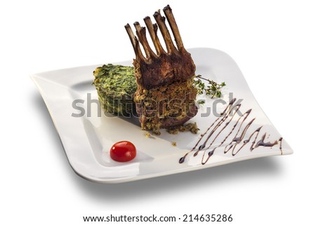 Baked Ribs With Spinach Puree isolated on white plate