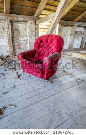 Red armchair in a barn
