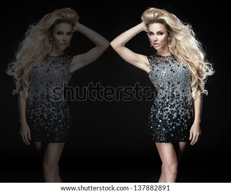 Fashionable young blonde sensual woman posing in elegant diamond dress. Long curly hair.