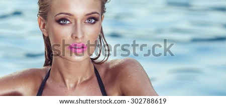 Portrait of beautiful blonde woman with perfect makeup and pink lips. Girl sunbathing, posing outdoor, looking at camera. Summer style.