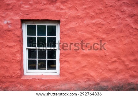 White window on the red wall of an old traditional welsh house in Cardiff, Wales, UK