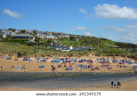 Holiday makers enjoying a Summers day at Mawgan Porth beach, Cornwall, United Kingdom