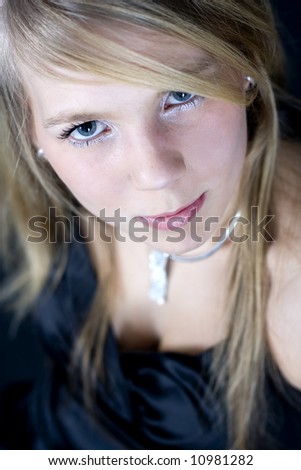 Young blonde woman with blue eyes and silver jewel