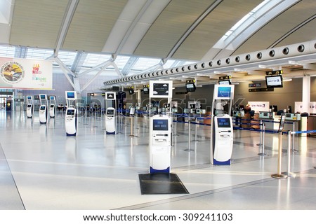 TORONTO, CANADA - MAY 29, 2014: Self-service check-in kiosks and check-in counters at Pearson International Airport in Toronto, Ontario, Canada. Pearson is the largest and busiest airport in Canada.