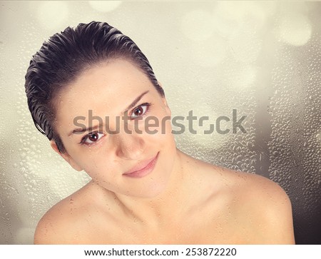 Close-up of beautiful wet woman face with water drop