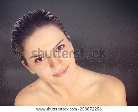 Close-up of beautiful wet woman face with water drop