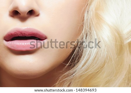 lips and hair of beautiful blond woman. part of face without eyes. beauty salon care