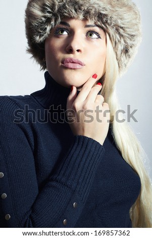 Beautiful Blond Woman in Fur Cap. Beauty Girl in Black Turtleneck. Winter Style. Red Manicure