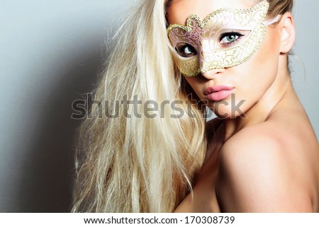Beautiful Blond Woman in a Carnival Mask.Masquerade. Sexy Girl. Beauty & Fashion