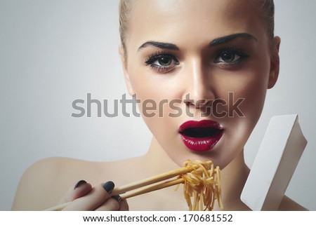 Beautiful Woman are Eating Noodles.Red Lips.Chinese Sticks. Fast Food Delivery. Enjoy meal