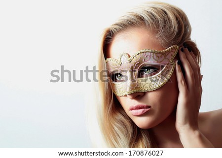 Beautiful Blond Woman in a Carnival Mask.Masquerade. Sexy Girl. Beauty & Fashion